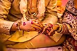 Indian wedding ceremony.hands of the bride held by a groom during a traditional ritual in an Indian Hindu Wedding