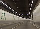 Seattle SR 99 Tunnel Interior Roadway with Curving Lanes and Emergency Exit Signs