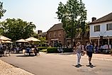 Street scene from historic Williamsburg Virginia at Merchants Square with people visible.