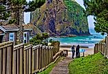Two brothers at the end of a public beach access path at Cannon Beach, Oregon, with the stunning coastline and Haystack Rock.
