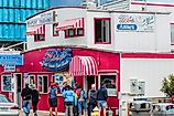 Dee Browning via Shutterstock. Newport, Oregon,USA: Tourist stand in front of Moe's seafood annex in downtown Newport.
