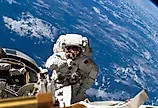 Astronaut Michael A. Lopez-Alegria pauses near the front of the International Space Station during an expedition. Via Shutterstock / RawPixel.com