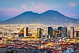 Naples, Italy with the financial district skyline under Mt. Vesuvius at twilight.