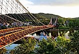 Barge going under the Famous Suspension Bridge at Wheeling, West Virginia.