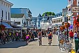 People at the downtown area of Mackinac Island, Michigan, to enjoy its many attractions.