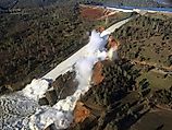 View of Oroville Dam's main spillway (center) and emergency spillway (top) collapsing. 