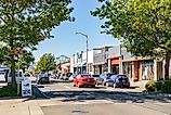 Cars on the street in downtown Astoria, Oregon with Astoria-Megler Bridge in the background