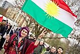 Kurdish woman with Kurdish flag. Via Shutterstock / Mahmoud Mahdi Photo