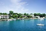 Lakefront homes and boats on the shores of Round Lake in Charlevoix, Michigan.