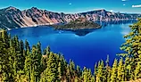 Wizard Island rises from the deep blue waters of Crater Lake in Crater Lake National Park, Oregon.