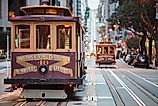 A cable car travels California, Van Ness and Market Streets. Via Shutterstock / Connect Images-Curated