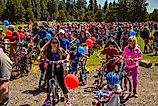 Children and adults just starting a ride in a 4th of july parade at Blask Butte Ranch resort near Sisters, Oregon. Editorial credit: Bob Pool / Shutterstock.com