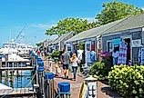 A row of eclectic shops along the harbor in Nantucket, Massachusetts. Image credit Mystic Stock Photography via Shutterstock