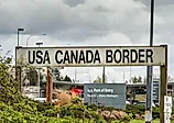 Surrey, British Columbia: BNRR Railway USA Canada border sign. Editorial credit: illuminaphoto / Shutterstock.com