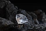 Natural rough diamonds on a pile of rocs close up photography.