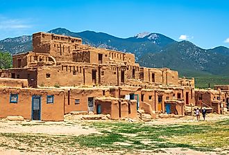 Tourists visit the historic Taos Pueblo, New Mexico. Image credit Sean Pavone via Shutterstock