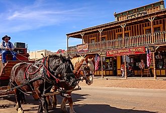 A stagecoach filled with tourists travels the historic streets of Tombstone, Arizona. Image credit CrackerClips Stock Media via Shutterstock