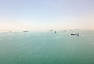 View of ships at anchor in the Great Bitter Lake at the halfway point of the Suez Canal. Image credit FabianIrwin via Shutterstock.