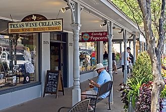 People walking around downtown Fredericksburg, Texas along the main street, via Peter Blottman Photography / iStock.com