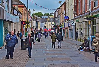 People walking around the shops in Brigend, Wales. Image credit: Colin Burdett via Shutterstock.