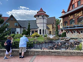 A couple of fellow tourists admiring the manicured naturescape and Bavarian architecture within Frankenmuth’s River Place Shops. Photo credit: Andrew Douglas