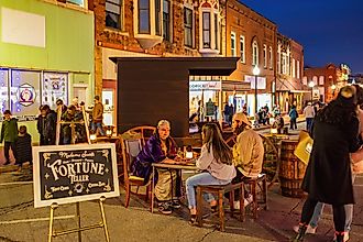 A fortune teller seated in a Victorian-style setting during the famous Guthrie Victorian Walk in Oklahoma.