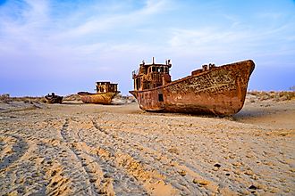 Rusty shipwreck lying on the seabed of the dried-up Aral Sea in Moynaq (or Muynak), a former fishing town in Karakalpakstan, Uzbekistan