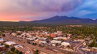 Blue and Orange color swirls around in the clouds at sunset over Flagstaff Arizona