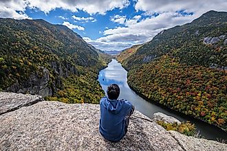 Man sitting on Indian Head Cliff at Adirondack Park, New York, USA.
