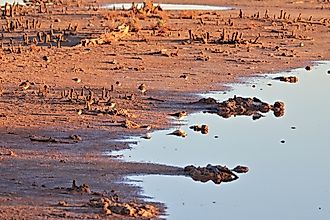 The red bluffs of the western edge of the Caprock, the Pecos River and Bitter Lakes National Wildlife Refuge at sunrise
