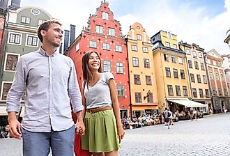 Smiling couple in Sweden's Stortorget Square in Gamla Stan.