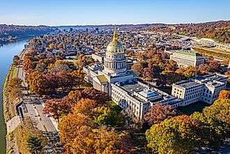 An aerial view of the West Virginia State Capitol Building and downtown Charleston with fall foliage.