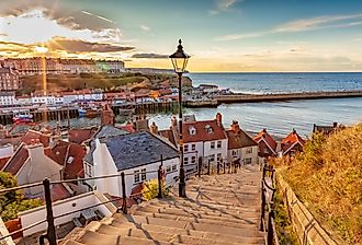 Famous 199 steps at sunset over the harbour at Whitby, England, UK. Image credit cally robin via Shutterstock