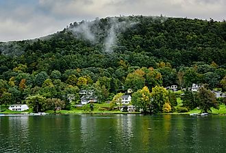 Homes along the shore of Ostego Lake, the source of the Susquehanna River in Cooperstown, New York. Image credit Steve Cukrov via Shutterstock