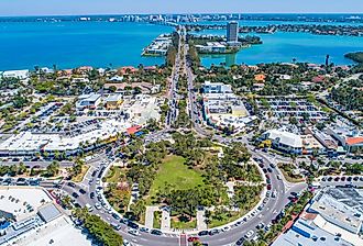 St Armands Circle in Sarasota, Florida. Drone image with sunny blue skies and crystal waters. Image credit Suncoast Aerials via Shutterstock.