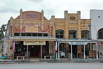 The Empresario Restautant and Hanging Tree Antiques buildings in the downtown historic courthouse square - Goliad, Texas, via JustPixs / Shutterstock.com