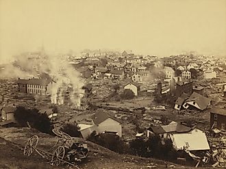 General view of Johnstown from high ground after the flood of May 31st, 1889. Horse drawn wagons and men work in the central mid-ground, possibly recovering bodies Editorial credit: Everett Collection / Shutterstock.com 