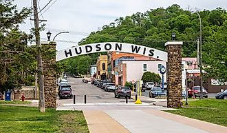 Sign and downtown street in Hudson, Wisconsin. Image credit Cheri Alguire via Shutterstock