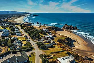 Aerial drone shot of coastal homes and beach in Bandon, Oregon.