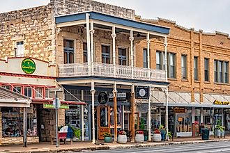 The shoppes housed in old historic buildings along Main Street through Fredericksburg, Texas, part of US 290, on a late spring morning.