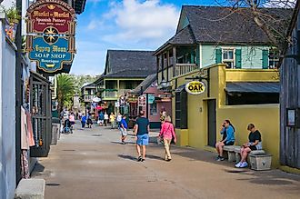 A few tourists walk along St. George street in St. Augustine, Florida, via KenWiedemann / iStock.com
