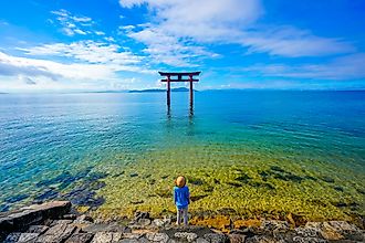 traveler woman and torii gate at Lake Biwa, Shiga Prefecture, Japan