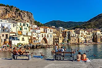 People on the beach of Cefalu, Italy. Image credit: rui vale sousa / Shutterstock.com.