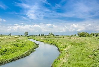 Crna River weaves through grass in North Macedona. Image credit Pargovski Jove via Shutterstock. 