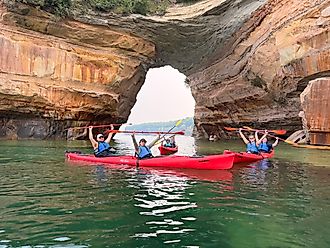 Pictured Rocks kayakers pose for a group photo in front of the famous Lover’s Leap sandstone arch. Image credit: Joshua Lutz