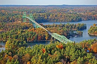 Thousand Islands Bridge across St. Lawrence River in fall in Thousand Islands National Park.