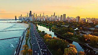 Aerial view of Chicago skyline at sunset, showing Lake Michigan shoreline