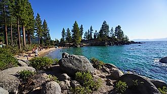 People enjoying a day by the Lake Tahoe beach in Incline Village, Nevada. Image credit: 1000Photography / Shutterstock.com.