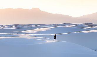 A female in black clothing admiring the view of mountains at White Sands National Park