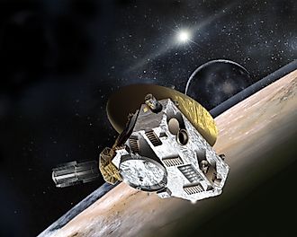 Artist’s concept of the New Horizons probe flying through the Pluto-Charon system in July 2015. Johns Hopkins University Applied Physics Laboratory/Southwest Research Institute, Public domain, via Wikimedia Commons